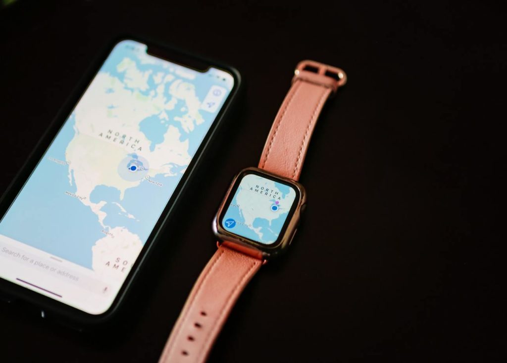 iPhone with map of North America next to Apple Watch with matching map on black background
