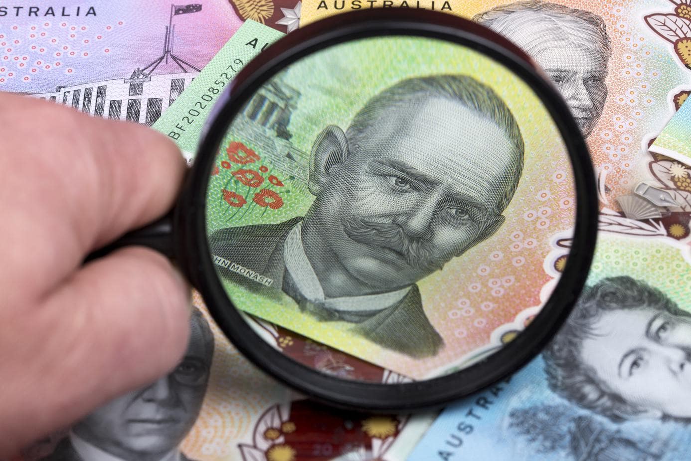Australian dollars in a magnifying glass
