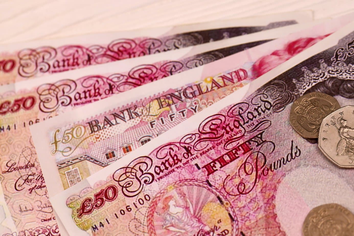 UK money bills and coins close up. Big amount of United Kingdom pounds